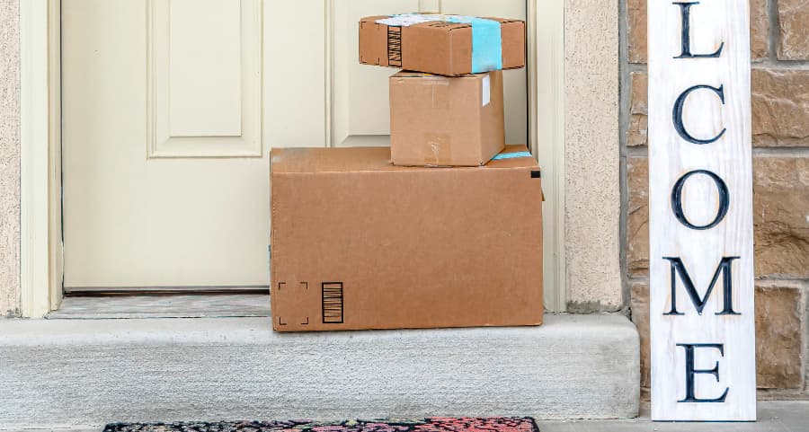 Boxes by the door of a residence with a welcome sign in Austin